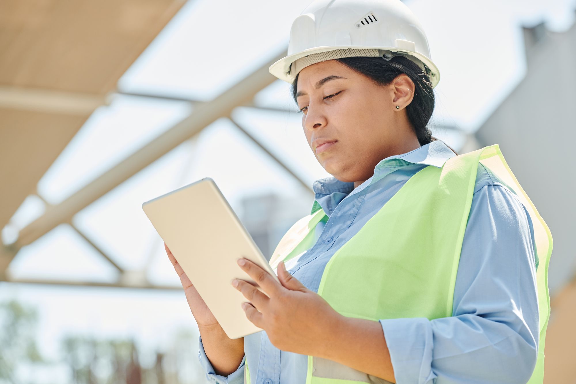 Reviewing plans and technology at an active industrial work site